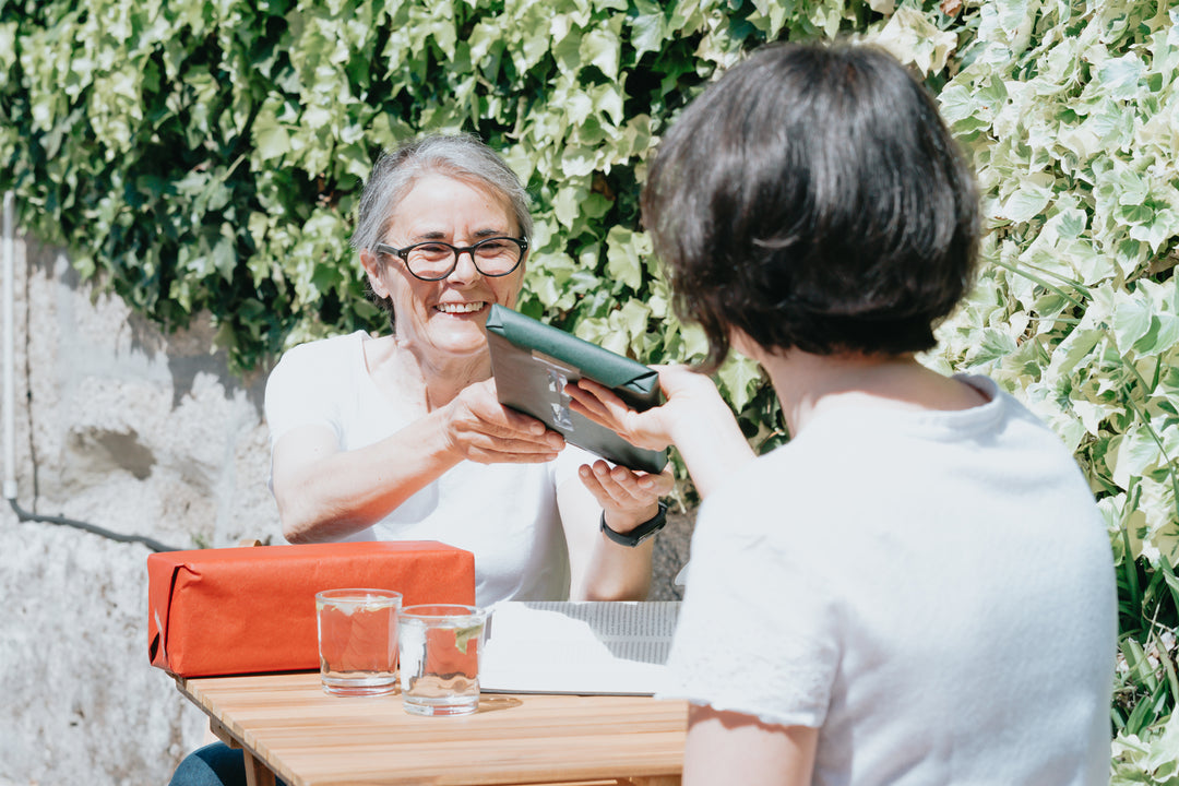 woman-accepts-a-wrapped-gift-from-a-friend[product-name]-letterseals.mom